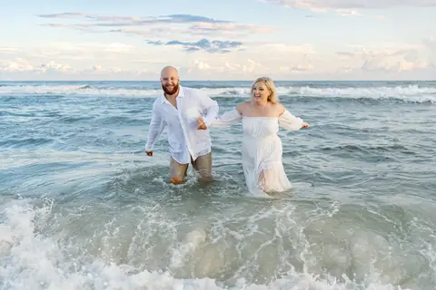 Ryan engagement, walking through the waves at Fort Morgan
